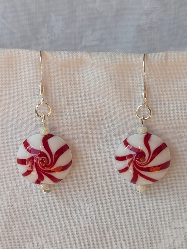 Handmade peppermint swirl Christmas earrings with red and white glass candy beads and pearly white accents on sterling silver hooks.
