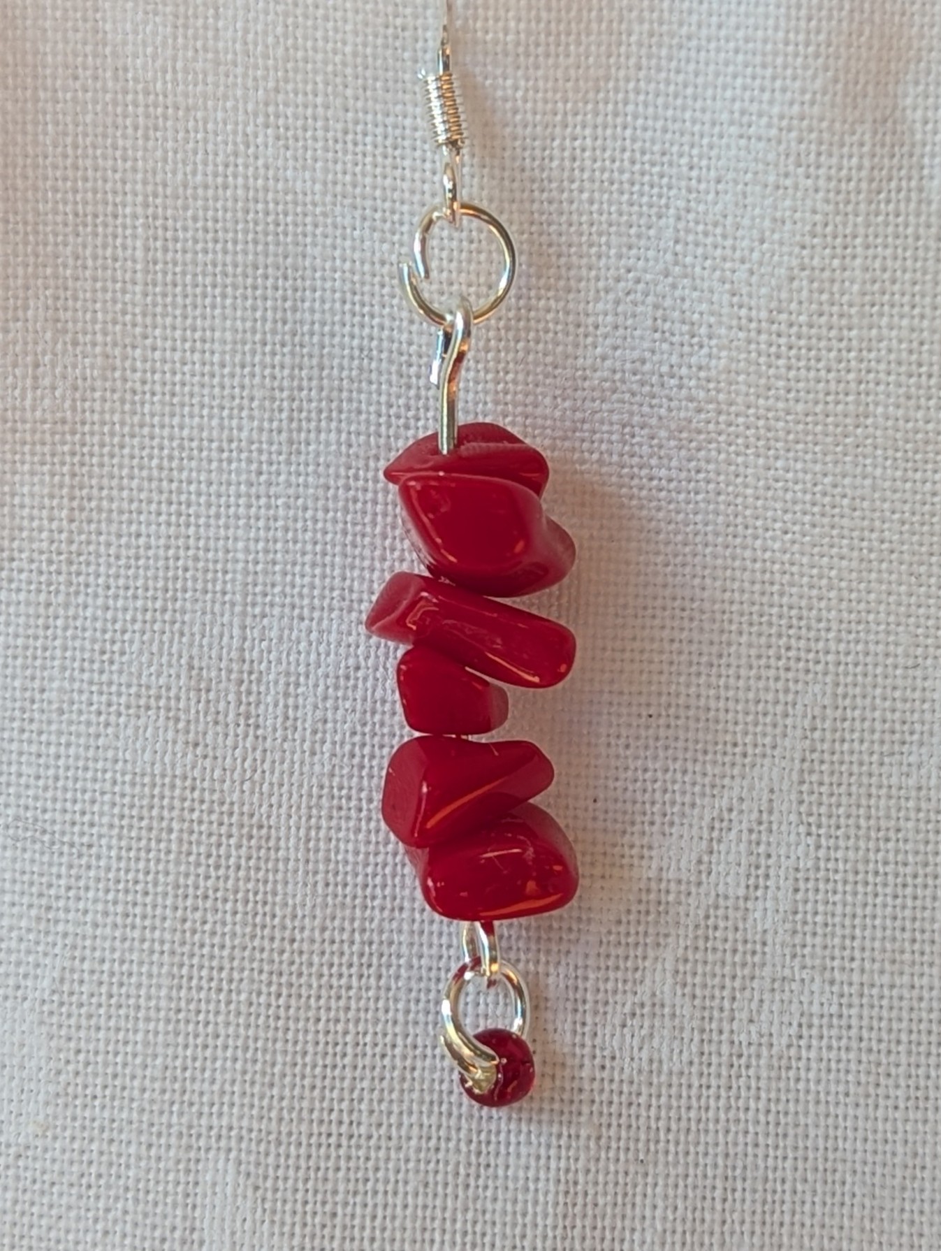 Handmade scarlet stone cascade earrings with red gemstone chips and small glass seed beads on sterling silver hooks.