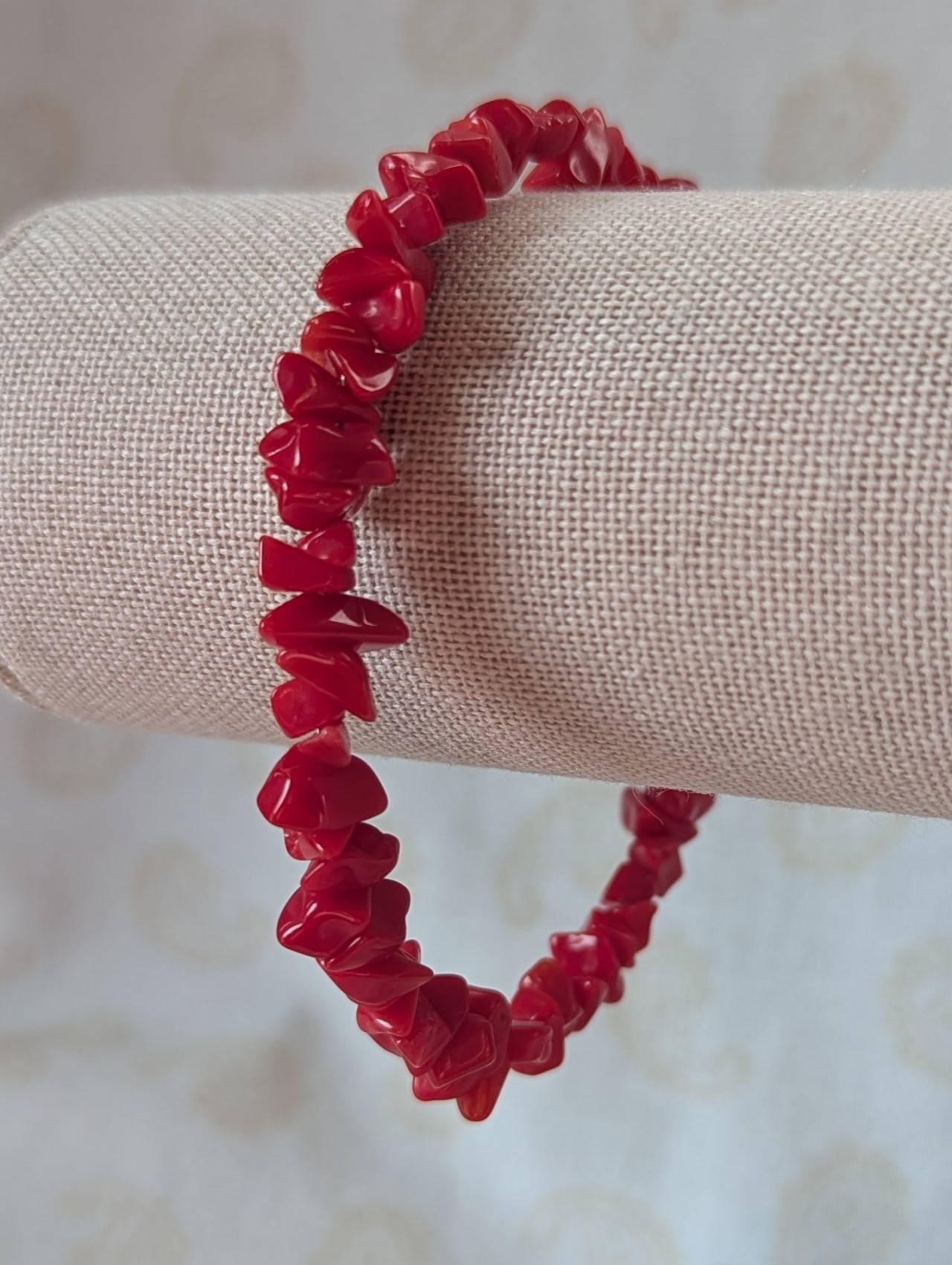 Red stone memory wire bracelet with polished cherry red chip stone beads and a silver-colored lobster clasp closure.