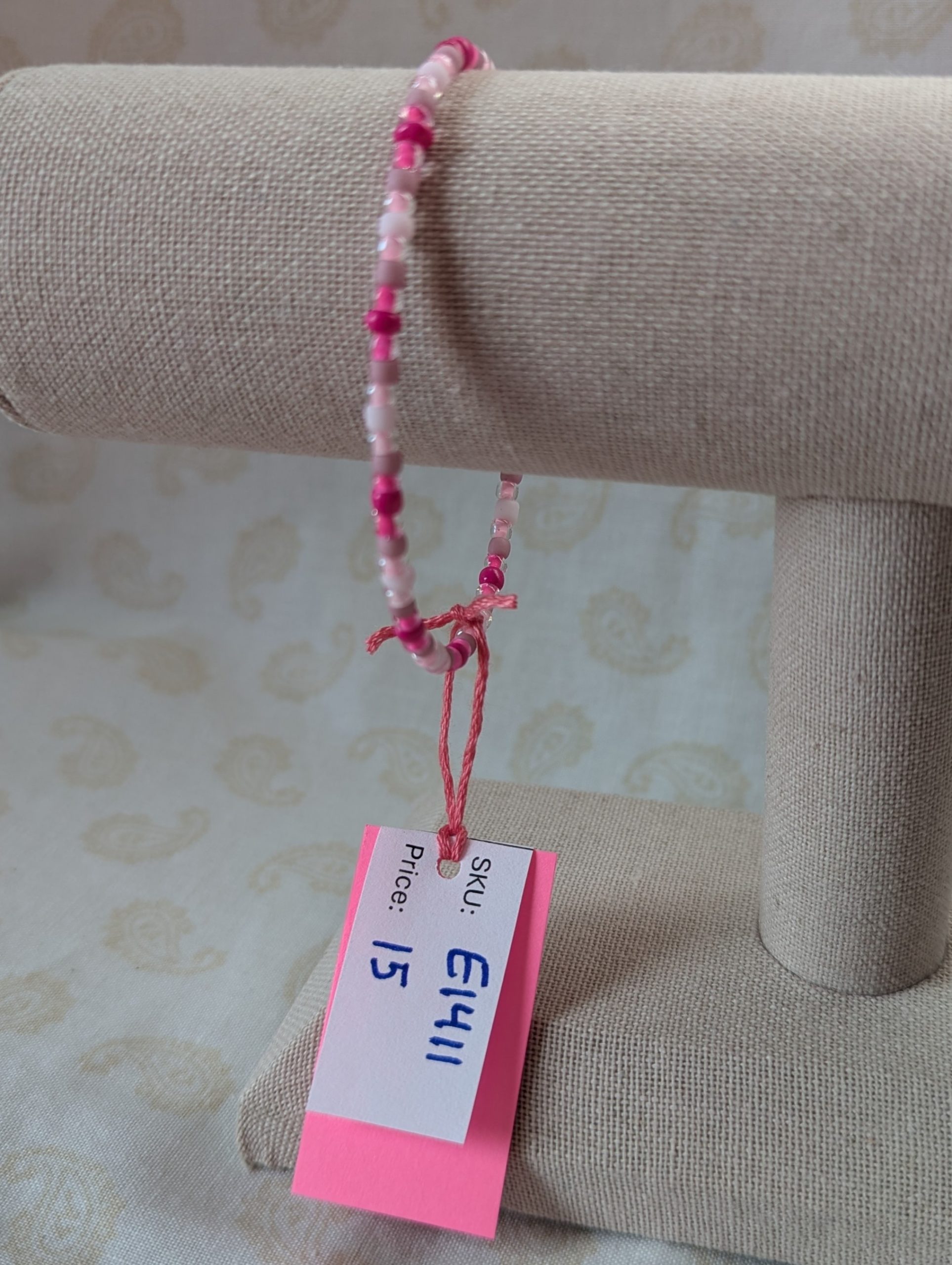 Pink memory wire bracelet with mixed pink beads in various textures and hues, finished with a silver-colored lobster clasp.