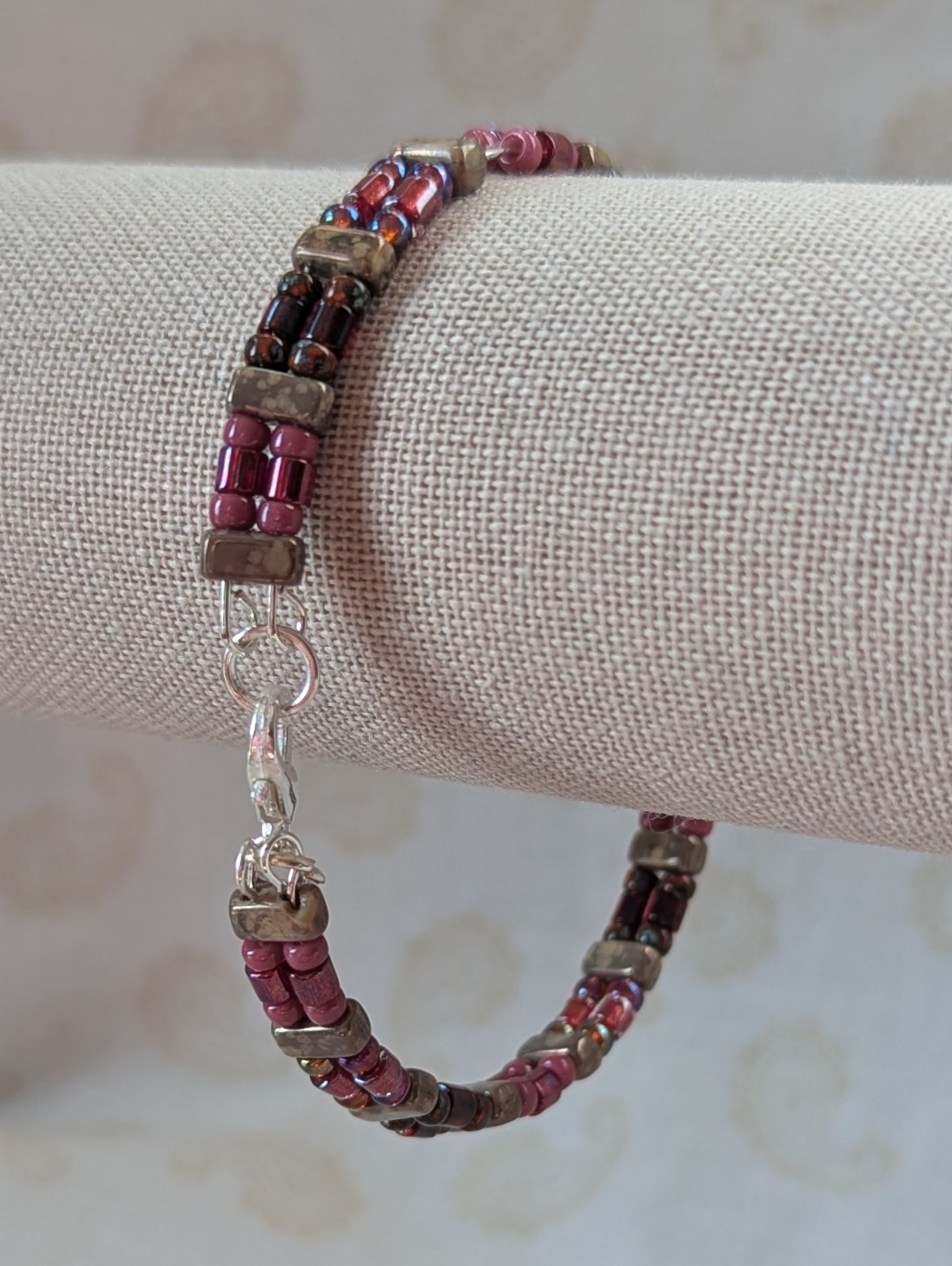 Double-strand memory wire bracelet with rose mauve, garnet, and taupe rectangular stone beads, finished with a silver lobster clasp.