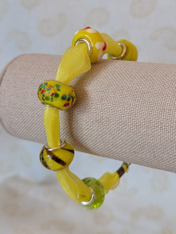 Sunshine Yellow Lampwork and Ribbon Bracelet: six yellow lampwork-style glass beads on a bright yellow ribbon with a lobster clasp closure