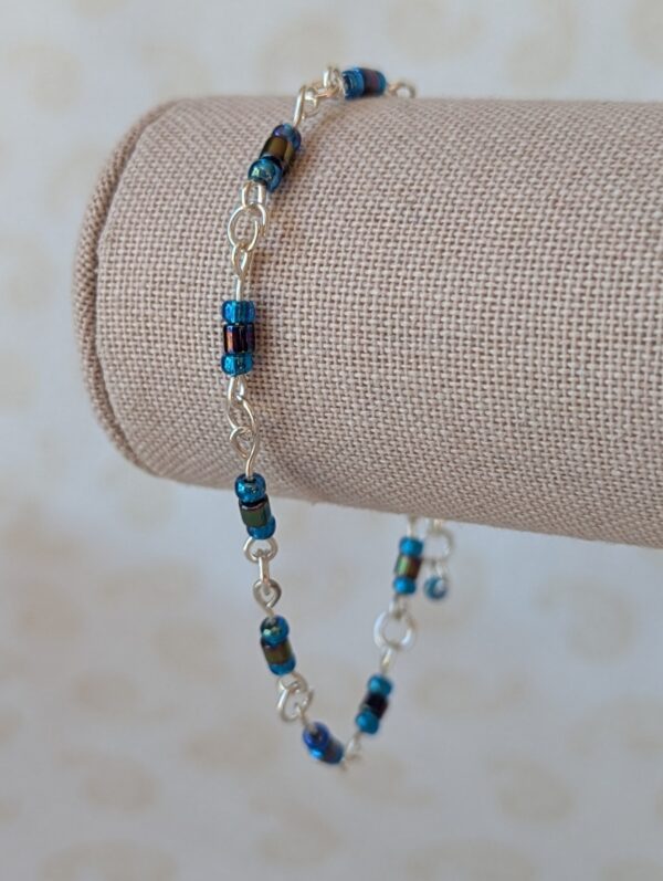 blue bead bracelet with silver chain and iridescent cornflower and metallic blue-black glass seed beads