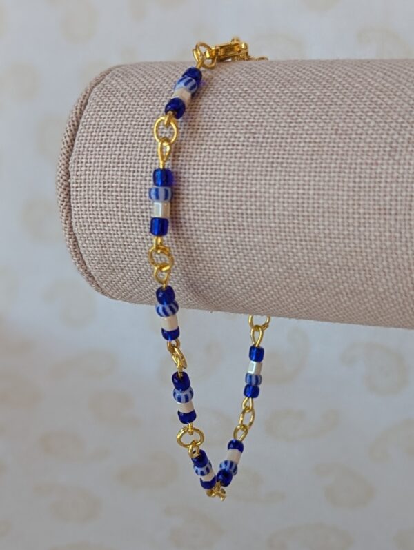 blue white bracelet with gold chain and ocean blue, pearly white, and striped glass seed beads