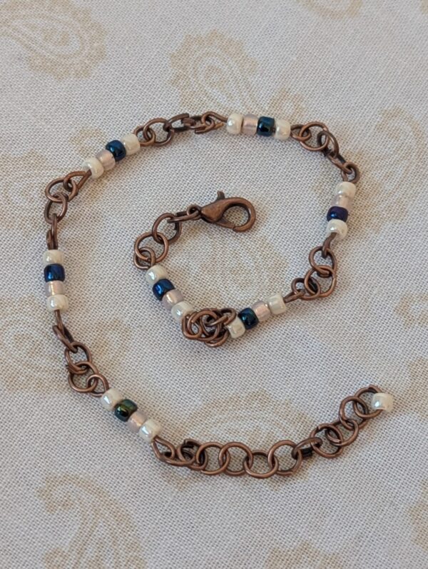 Bronze chain bracelet with cream and indigo blue glass seed beads and lobster clasp