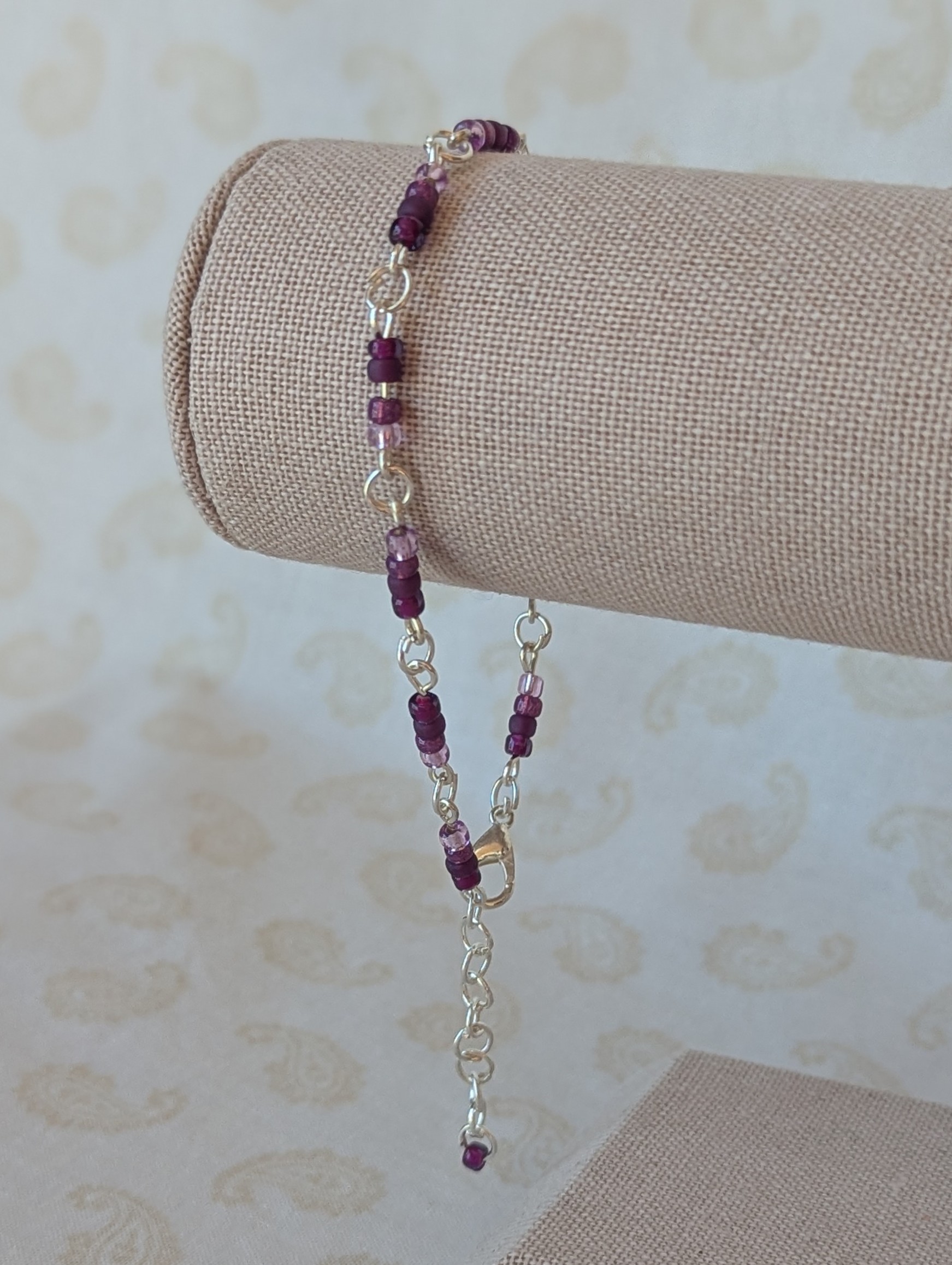 Silver-toned chain bracelet with gradient purple glass seed beads in lilac, lavender, and plum tones