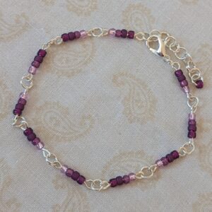 Silver-toned chain bracelet with gradient purple glass seed beads in lilac, lavender, and plum tones