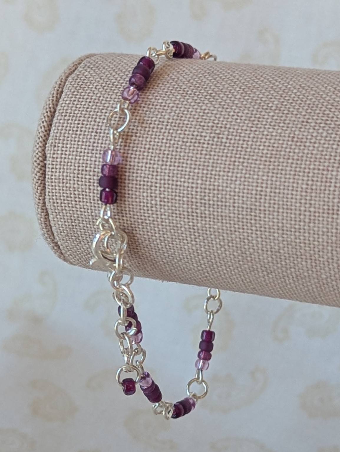 Silver-toned chain bracelet with gradient purple glass seed beads in lilac, lavender, and plum tones