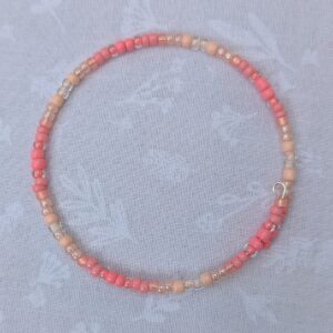 pink gradient bracelet with rose-gold memory wire and pale blush glass seed beads in mixed textures