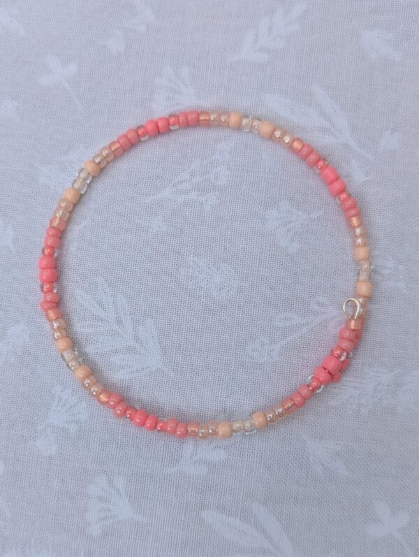 pink gradient bracelet with rose-gold memory wire and pale blush glass seed beads in mixed textures
