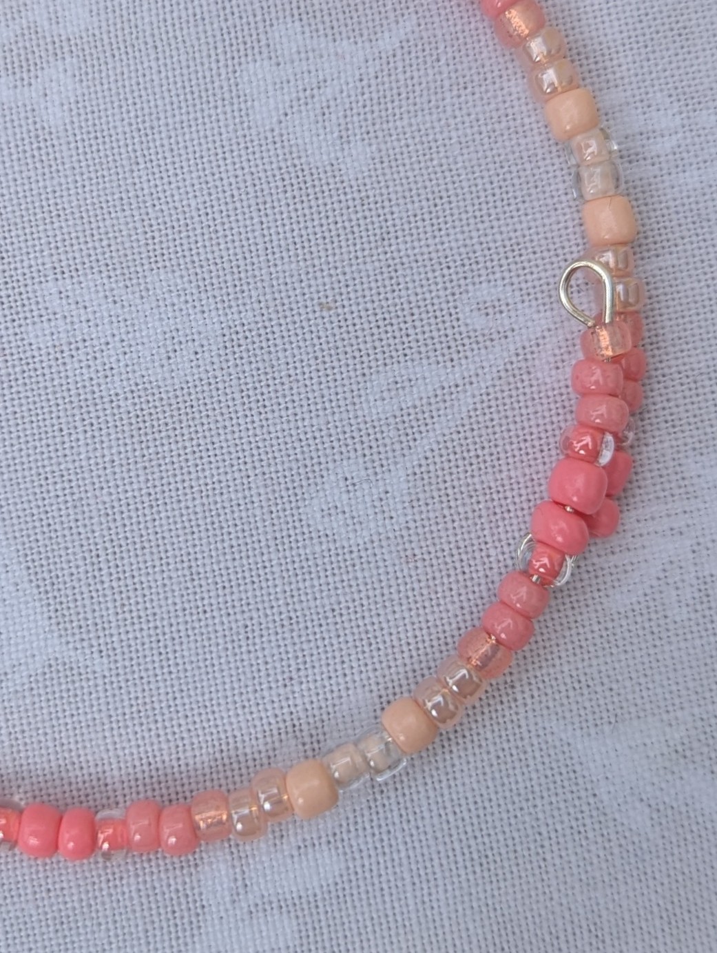 pink gradient bracelet with rose-gold memory wire and pale blush glass seed beads in mixed textures