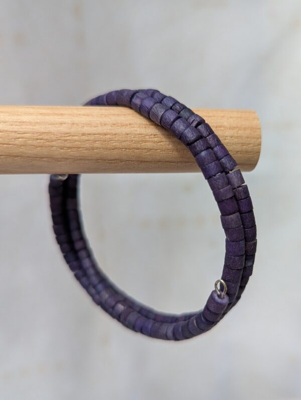 blue wrap bracelet with navy wooden cylindrical beads on steel-colored memory wire
