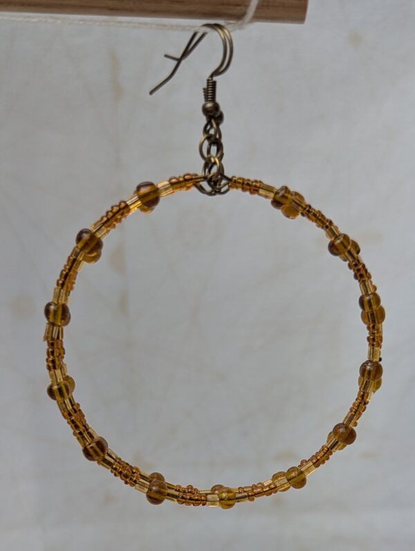 Handmade amber gold beaded hoop earrings with bronze-toned wire, translucent honey-colored beads, and antique bronze French hooks.