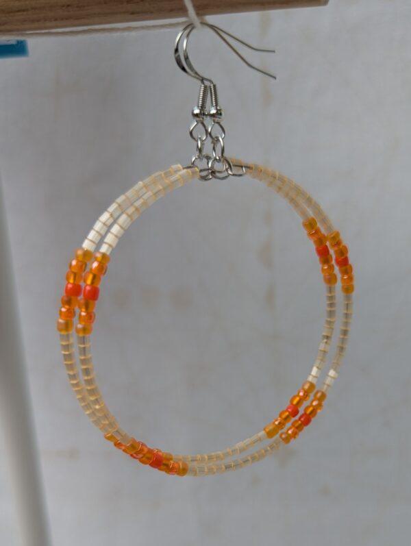 Handmade rose gold hoop earrings with ivory, amber, apricot, coral orange, and tangerine glass beads on memory wire with matching French hooks.