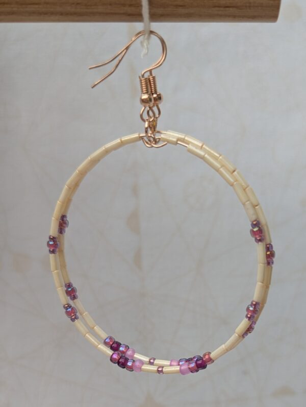 Handmade rose gold hoop earrings with ivory tube beads and lavender, mauve, plum, and orchid purple glass bead accents on rose gold French hooks.
