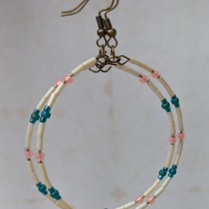 Handmade ivory hoop earrings with blush pink and teal glass bead accents on bronze memory wire and bronze French hooks.