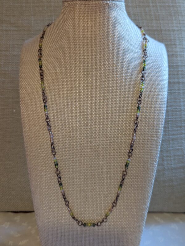 Bronze chain necklace with gradient green glass seed beads in moss, olive, and forest tones with lobster clasp
